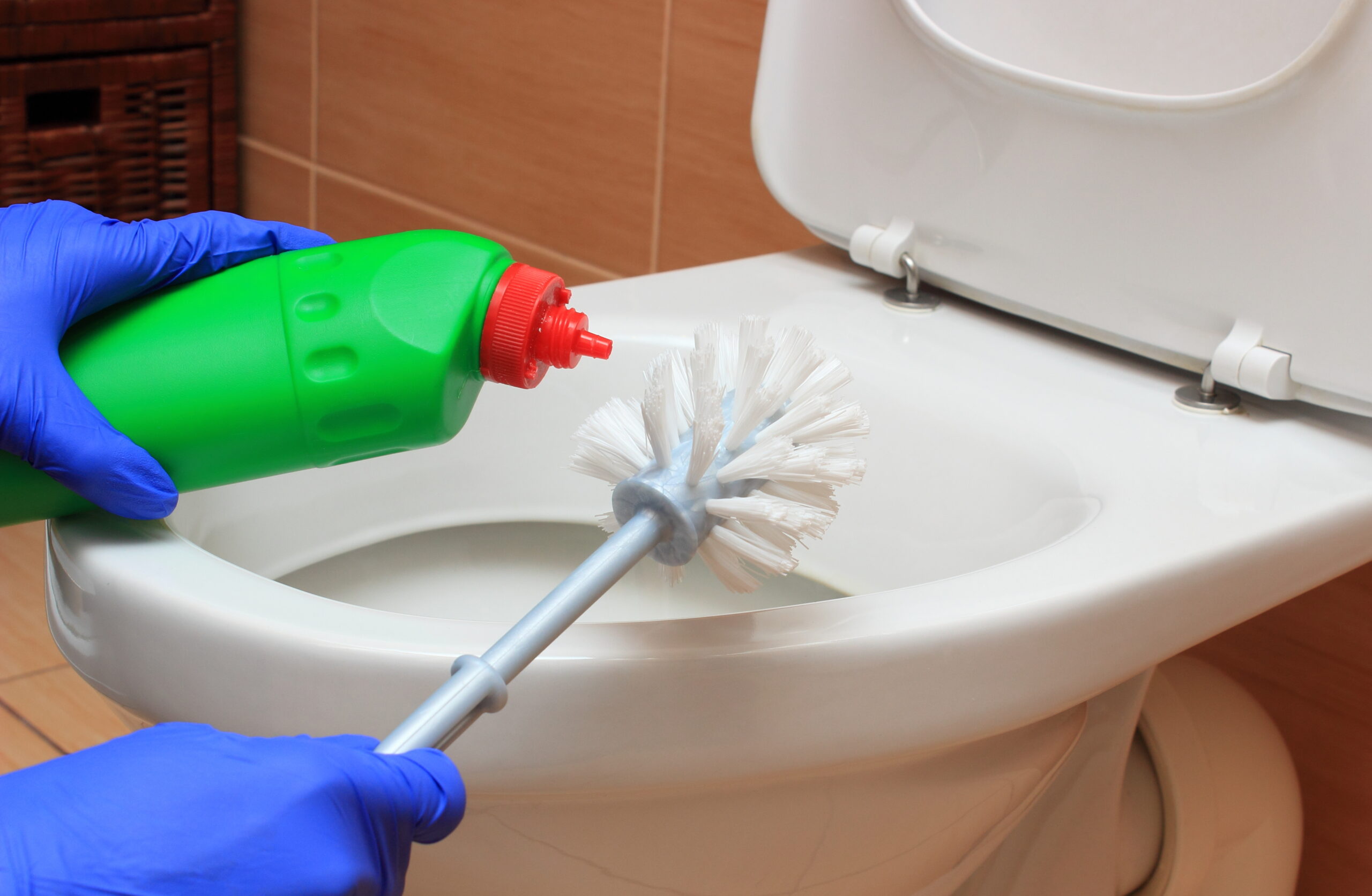 Hand,Of,Woman,In,Blue,Glove,Cleaning,Toilet,Bowl,Using