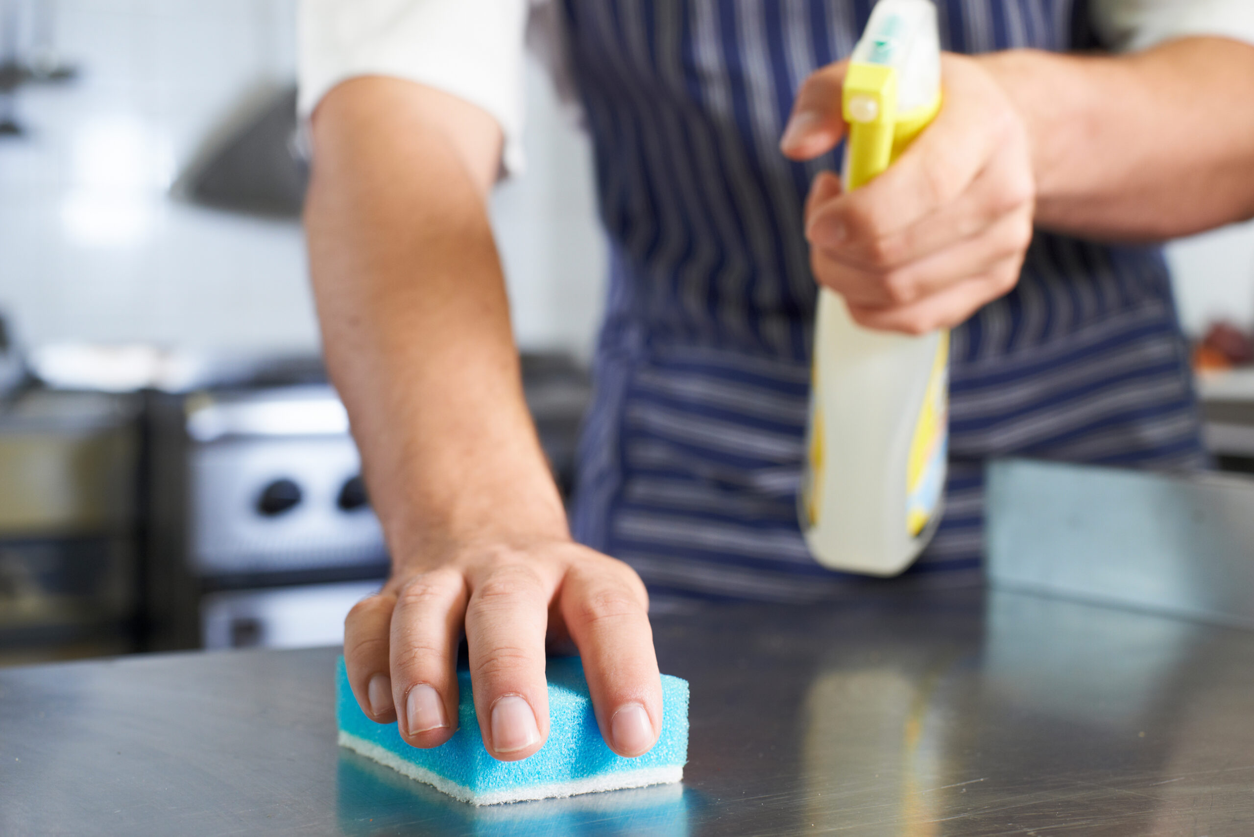 Close,Up,Of,Worker,In,Restaurant,Kitchen,Cleaning,Down,After